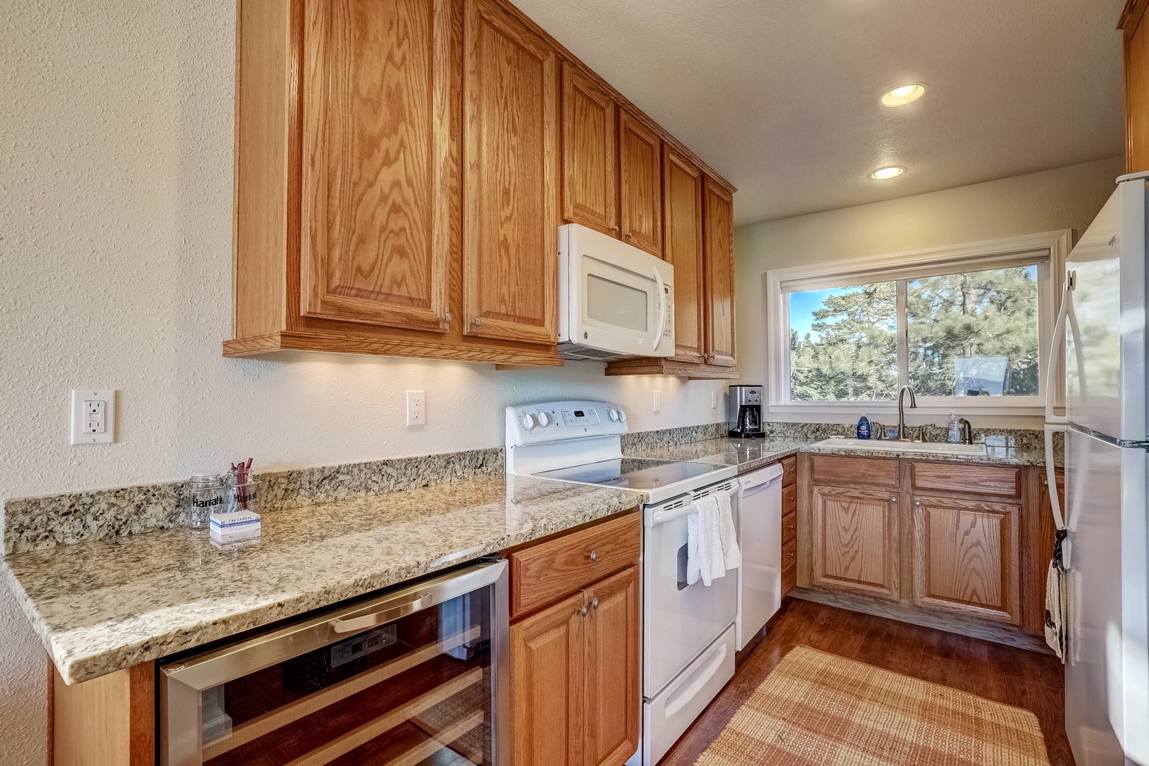 Full kitchen with wine fridge, dishwasher, and standard drip coffee maker