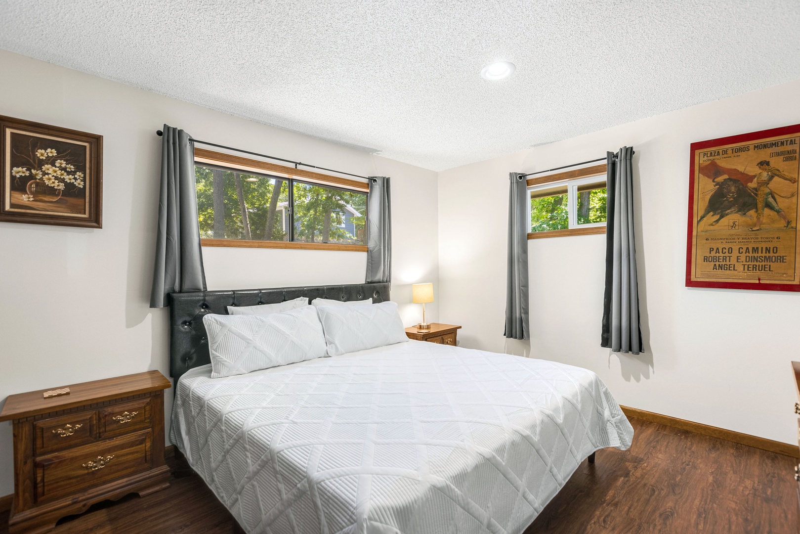 The 1st of 2 spacious main-level bedrooms, with a king bed & Smart TV