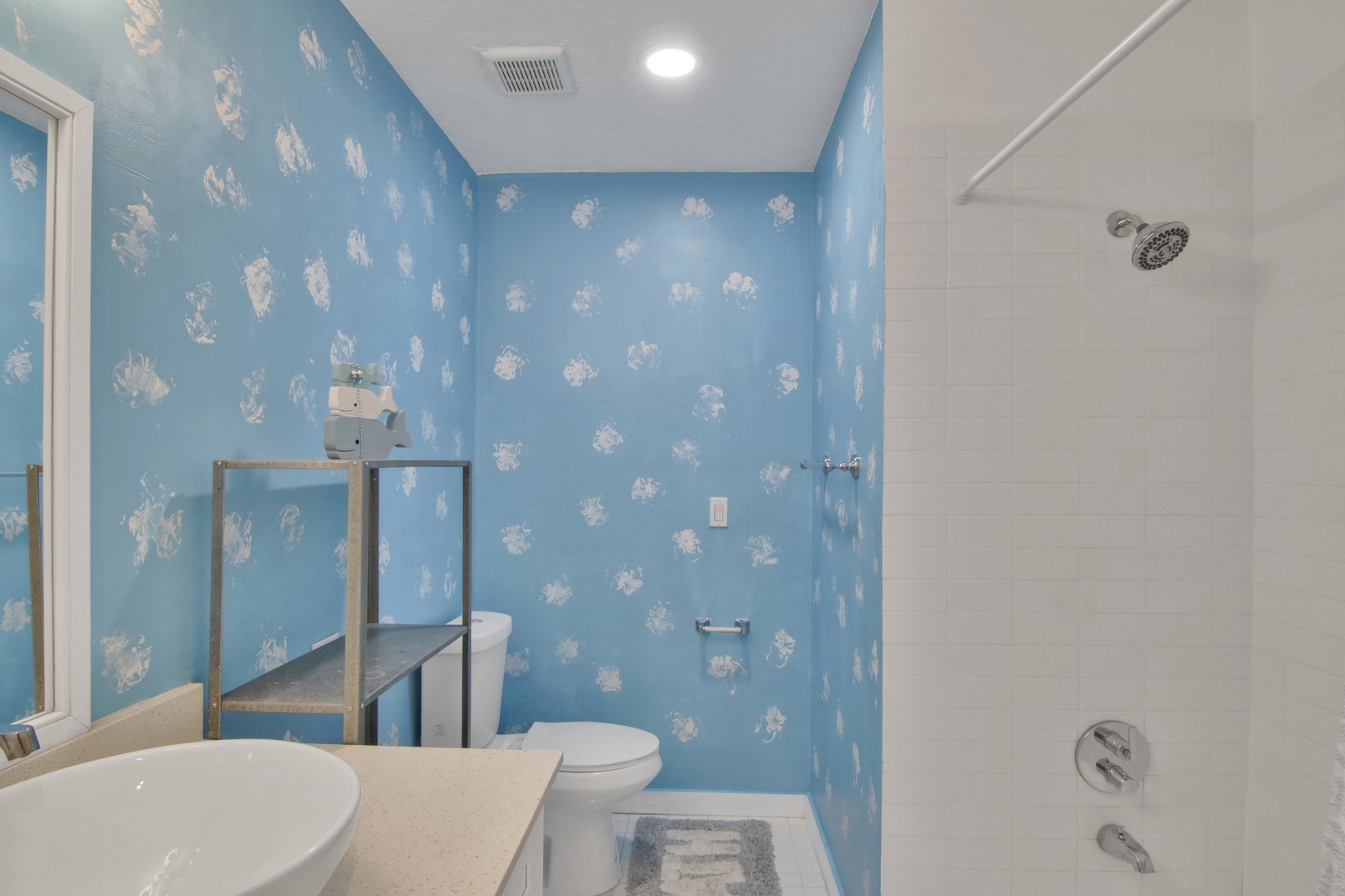 Unit 2: The ensuite bathroom includes a single vanity & shower/tub combo