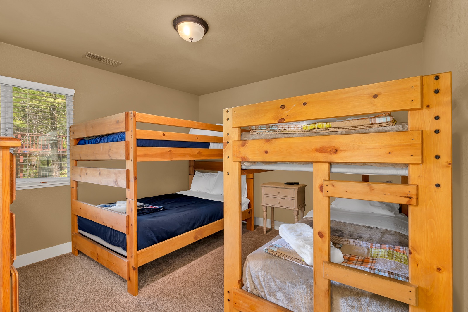 The 2nd  lower-level bedroom offers 2 twin-over-twin bunkbeds & a Smart TV