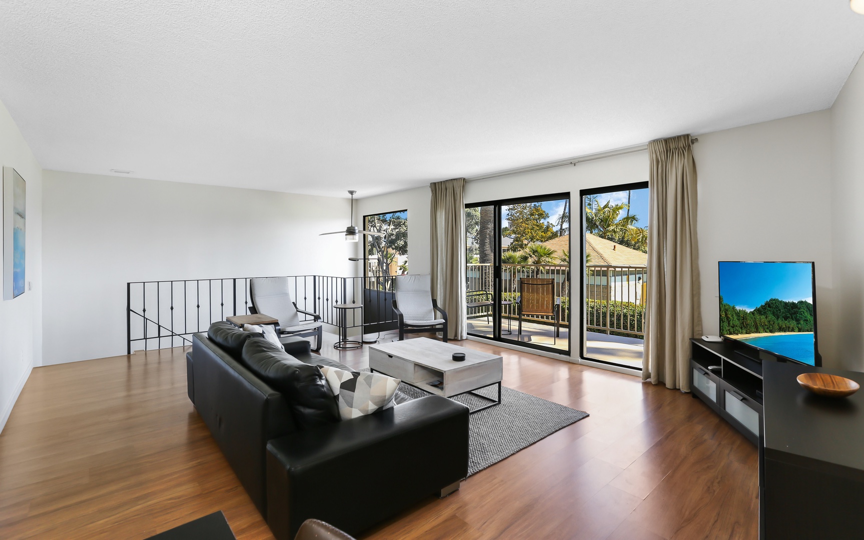 Open living space with TV, and balcony with beautiful view of Channel Park
