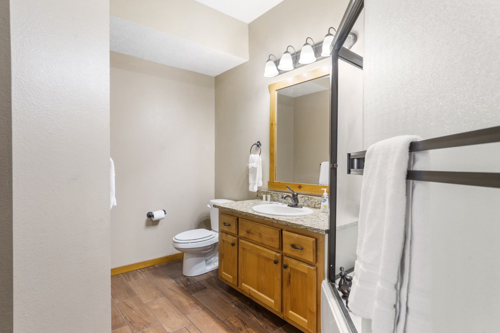 This ensuite bathroom offers a single vanity & oversized shower/tub combo