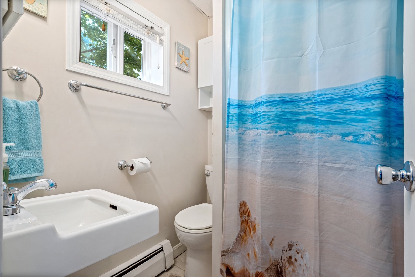 Wash up in the full bath, featuring a pedestal sink & shower