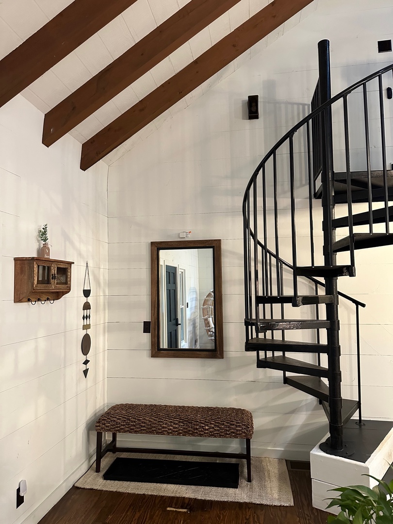 The bench seat and mirror, next to the spiral staircase,  are perfect to kick off your shoes from a long day's excursion or a last minute spot check before leaving to go out for the day.