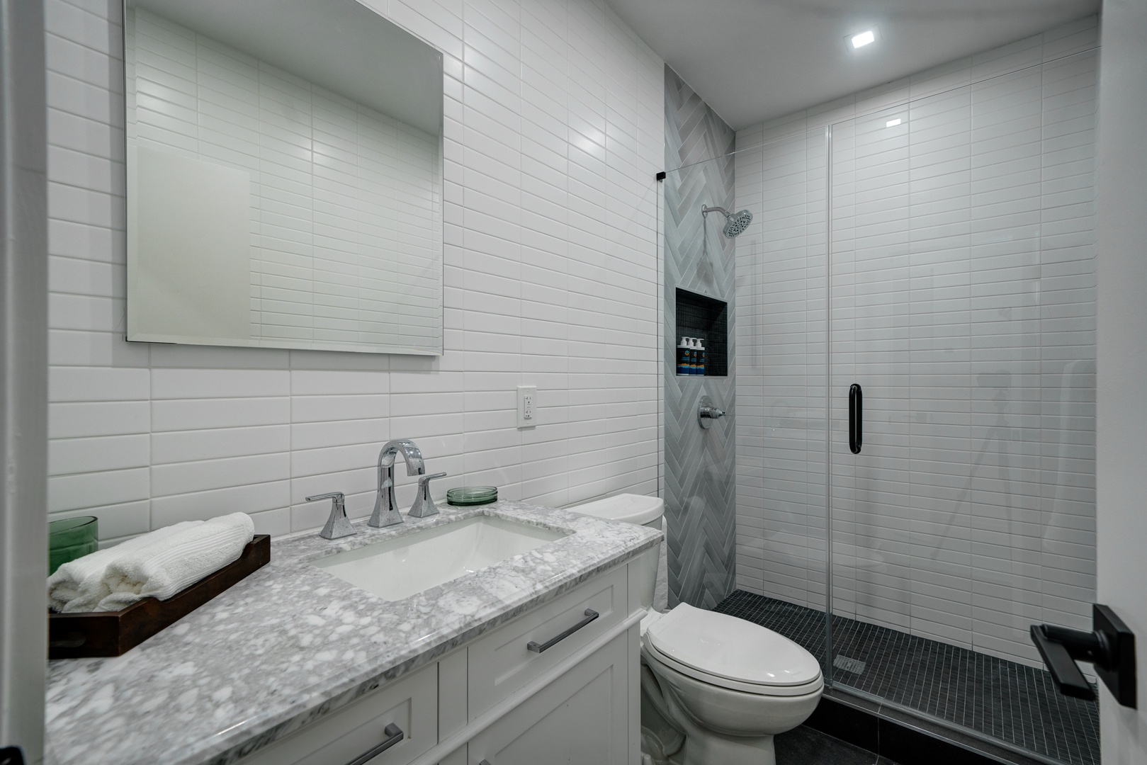 A single vanity & glass shower await in the final full bathroom