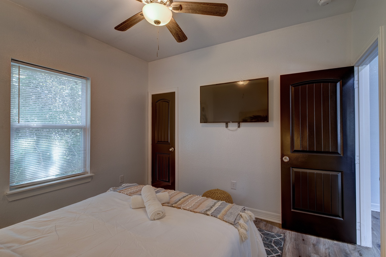 The third bedroom sanctuary showcases a queen-sized bed & Smart TV