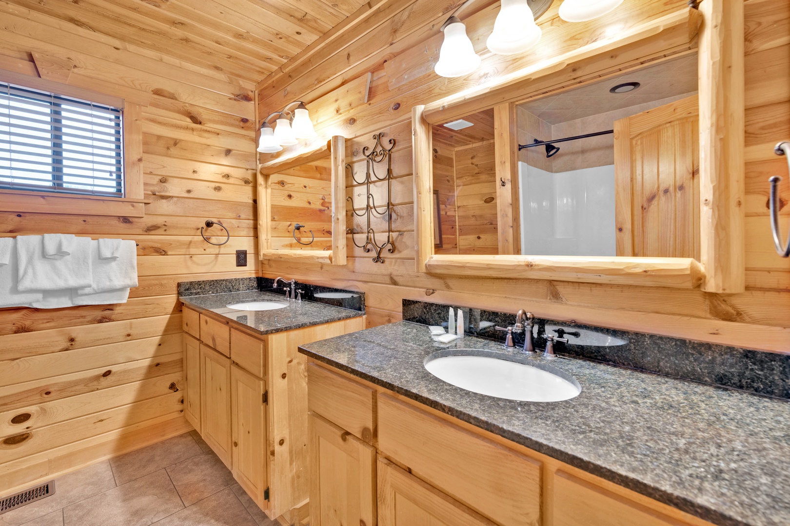The second-floor full bathroom offers dual vanities & a shower/tub combo