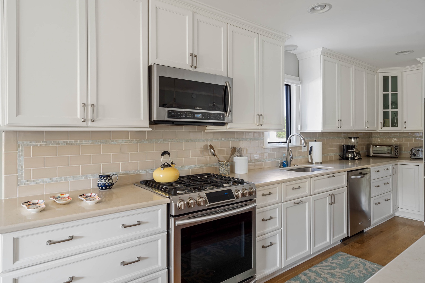 A gorgeous, open kitchen with beautiful amenities, ample storage, and plentiful counter space