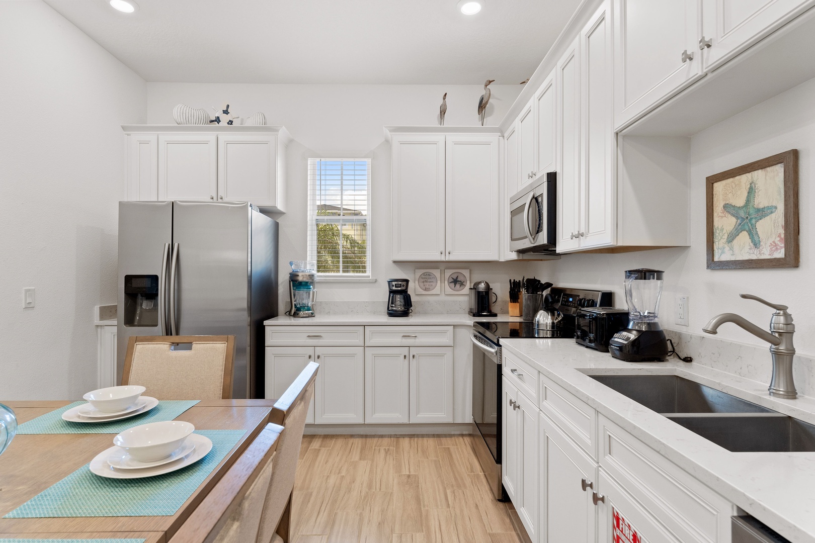 The beachy eat-in kitchen offers ample space & all the comforts of home