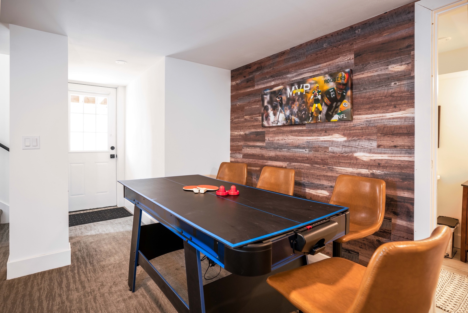 Basement game room with living space, Smart TV, ping pong, foosball, game table, and children area