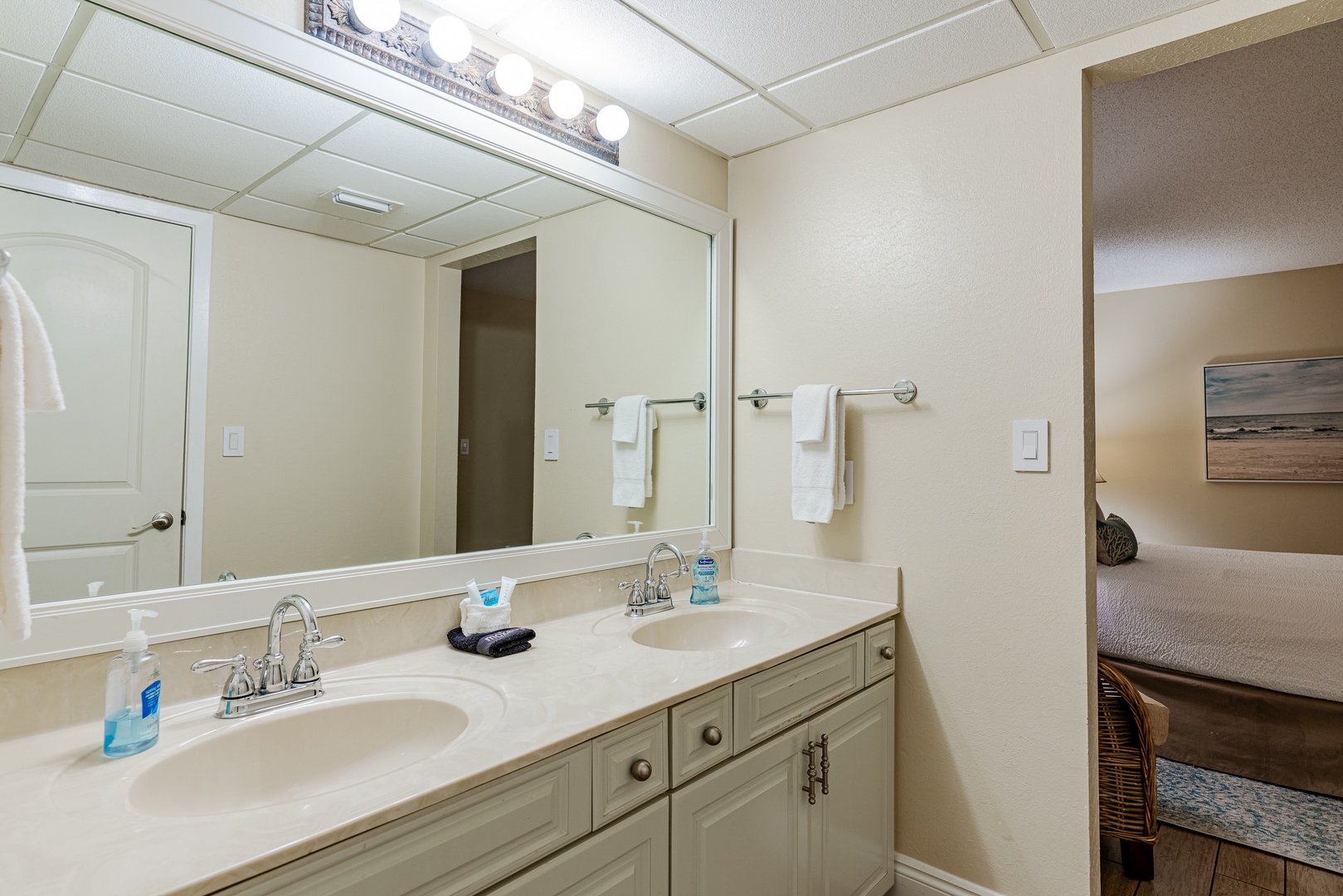 Dual sinks in primary bathroom with great lighting.