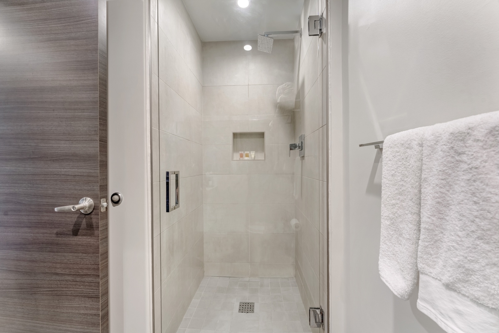The full bathroom offers a single vanity & spa-like glass shower