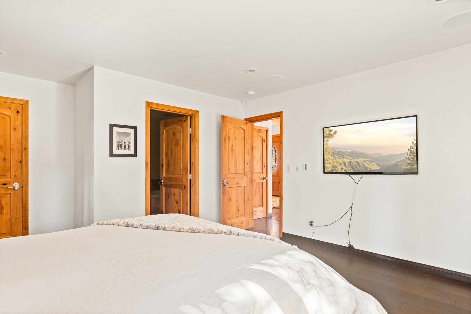 Bedroom 1 with Queen bed, patio access, Smart TV, and en-suite