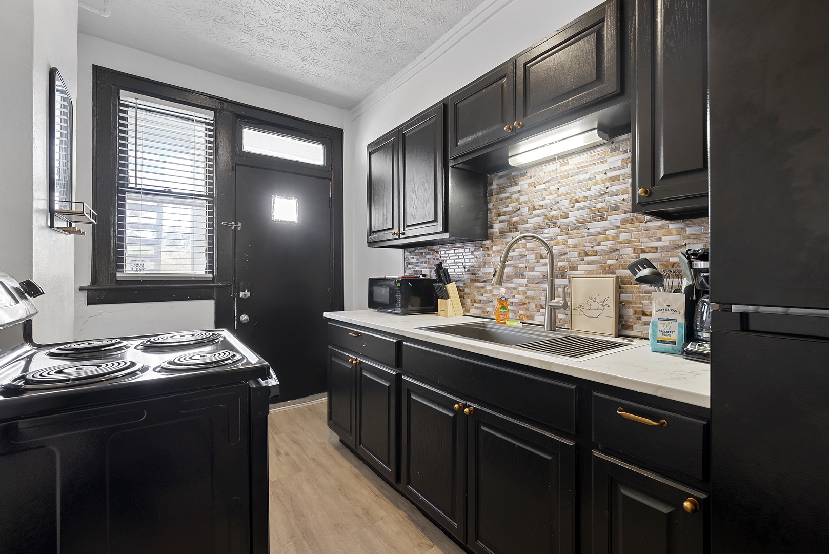 The sleek kitchen in Apartment 1166 offers ample storage & every home comfort