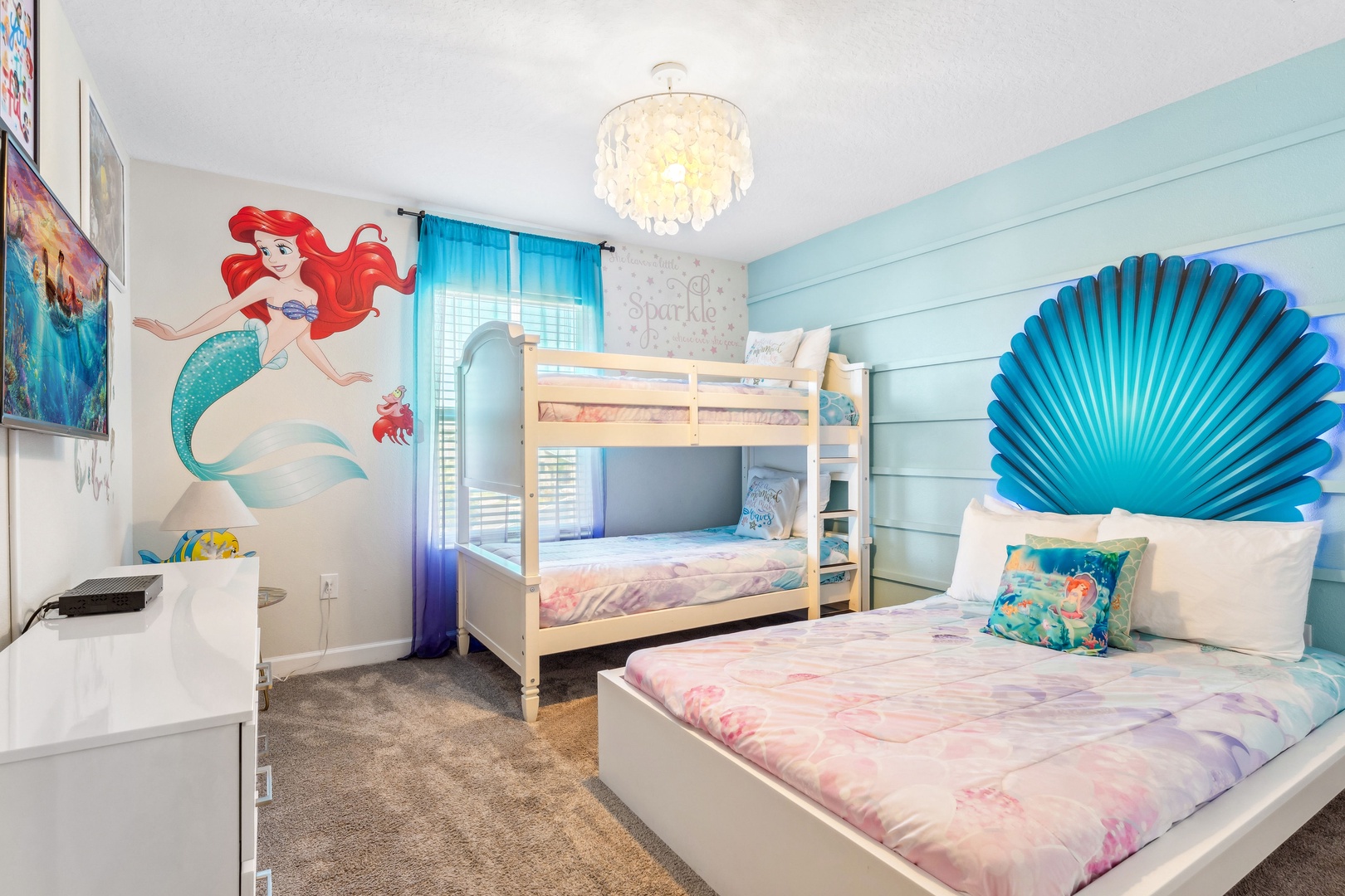 This  cozy Little Mermaid bedroom featuring a twin bunkbed and full-size bed