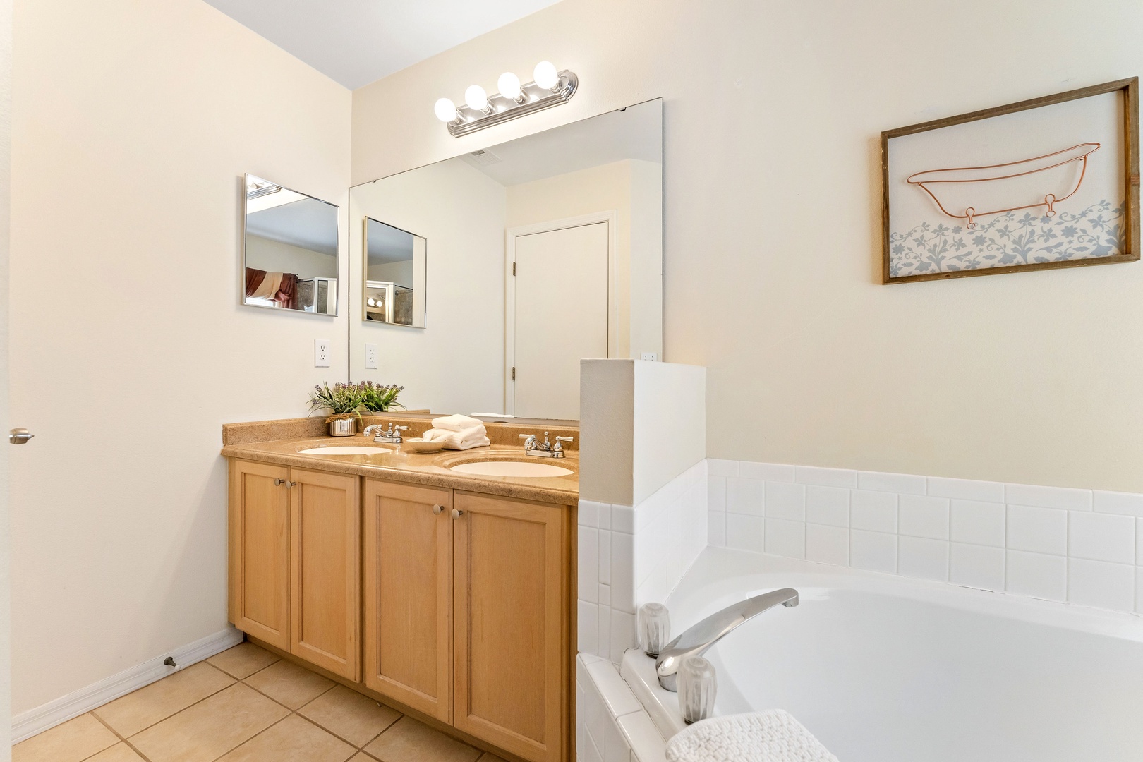 A double vanity soaking tub & walk-in shower is available in this ensuite bath