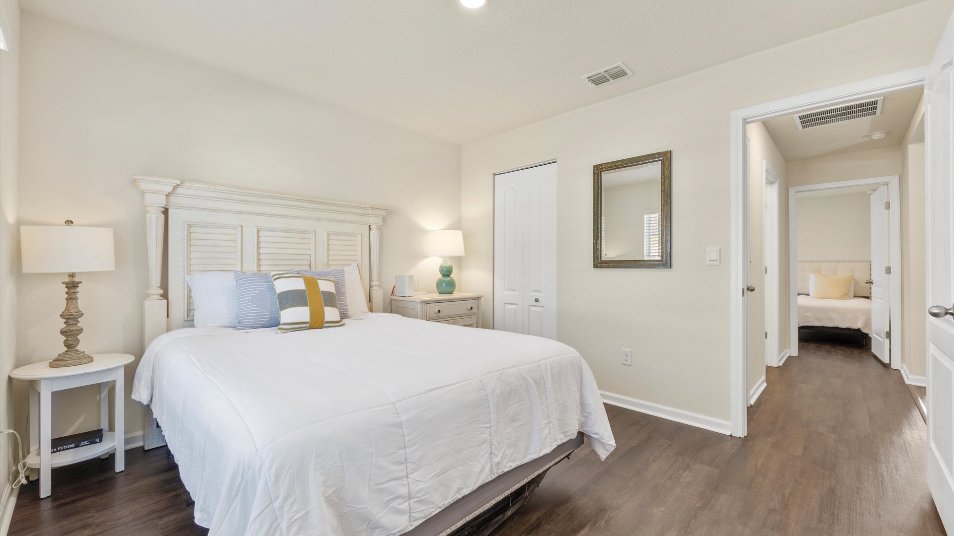 This spacious bedroom includes a queen-sized bed & Smart TV