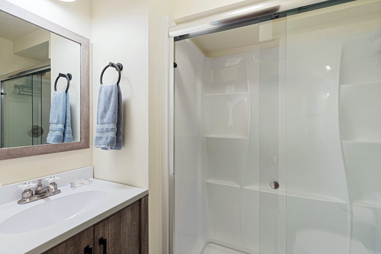 A single vanity & glass shower are available in the lower-level full bath