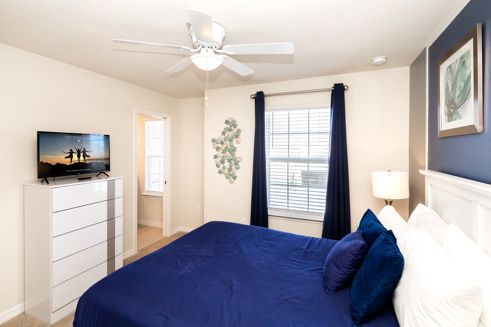 This 2nd floor queen suite offers a private en suite, Smart TV, & ceiling fan