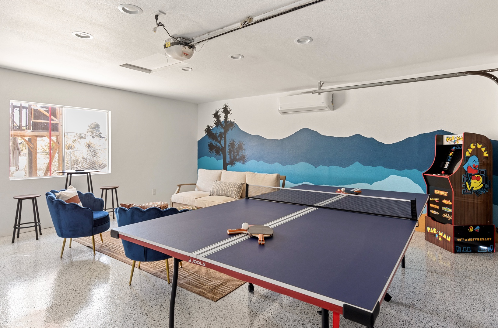 Game room with seating area, ping pong table, board games, and PacMan game