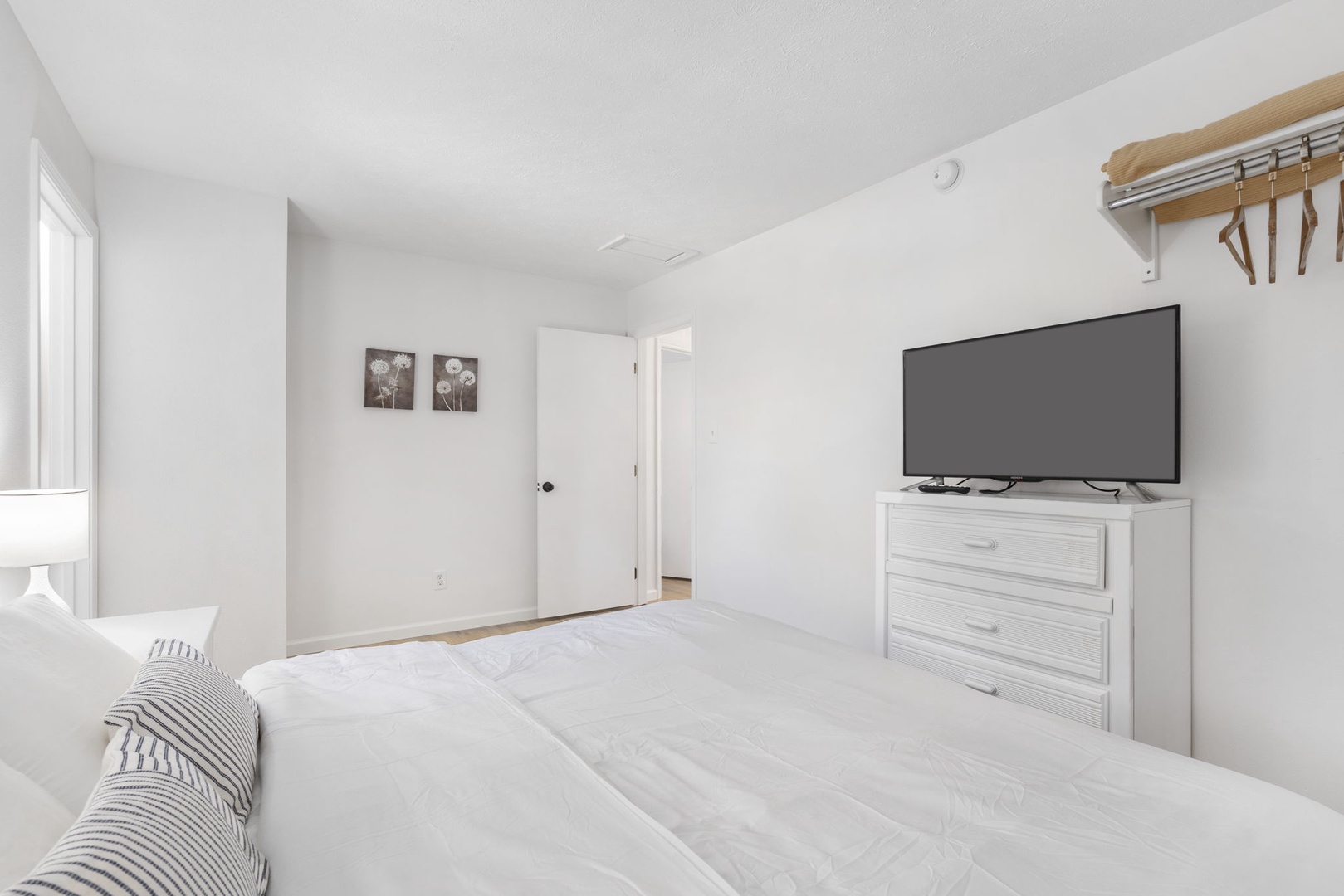 The final 2nd floor bedroom includes a king bed, Smart TV, & private en suite