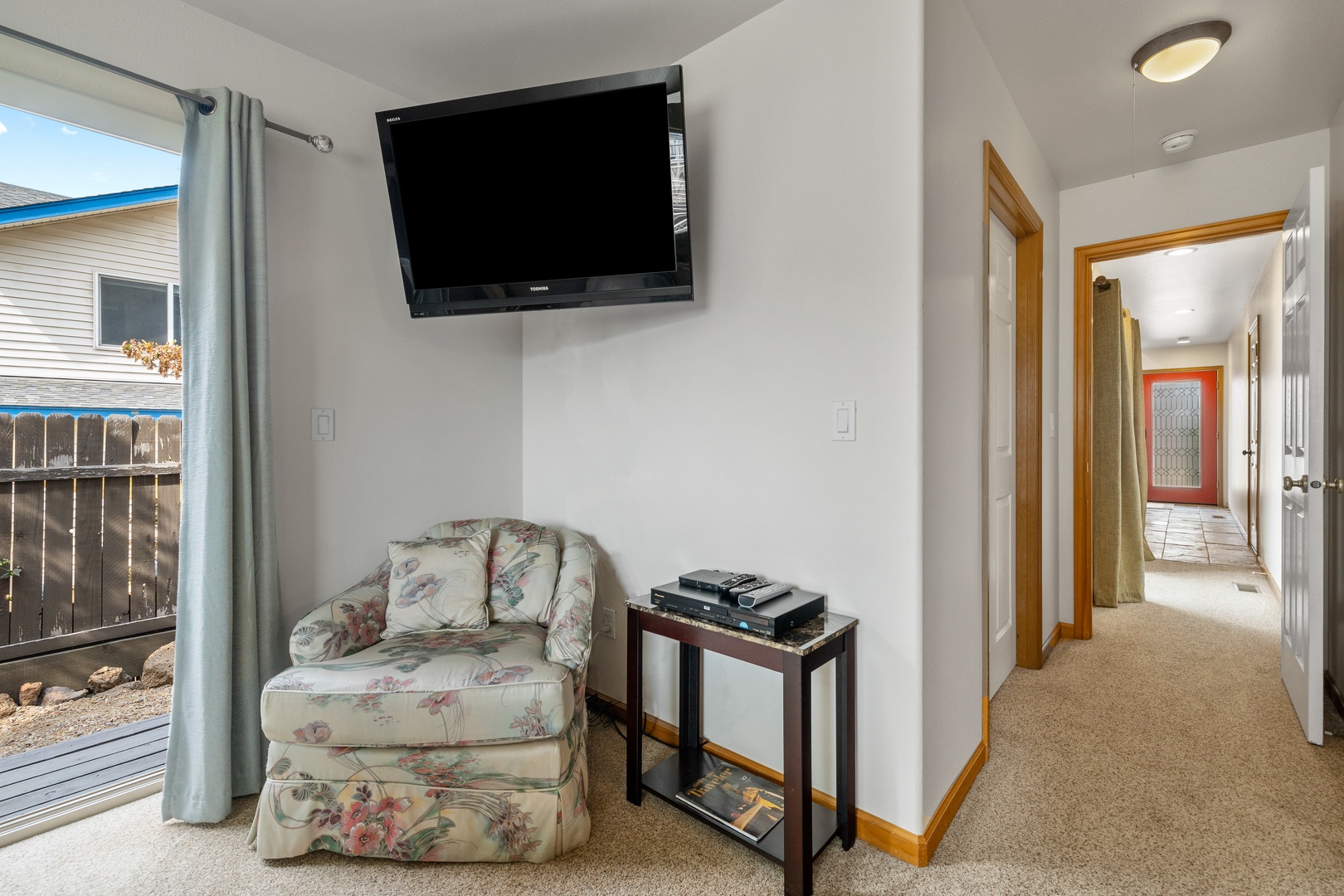 The 1st floor king suite offers a private en suite, TV, ceiling fan, & patio access