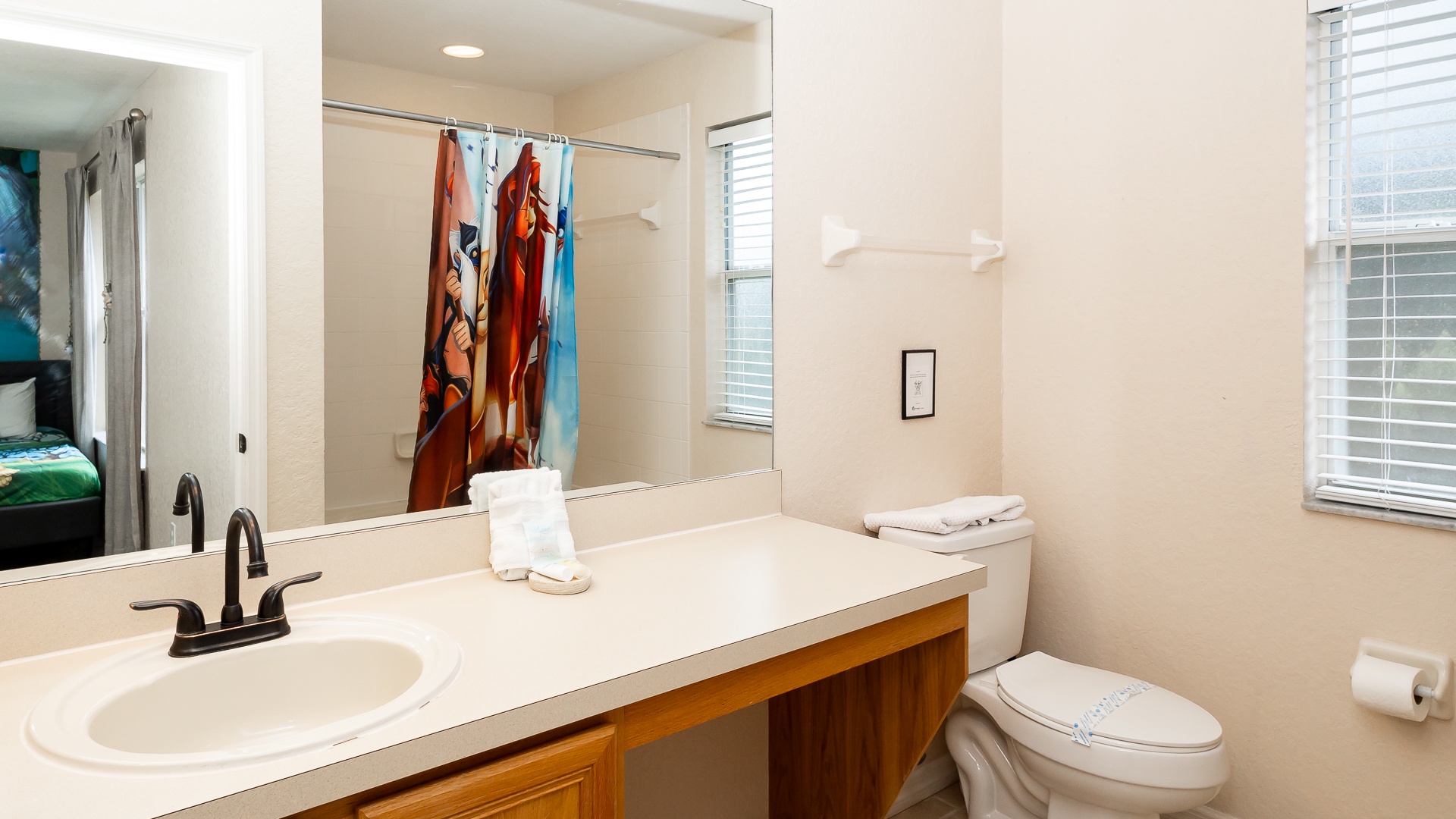 This en suite bath includes an oversized single vanity & shower/tub combo