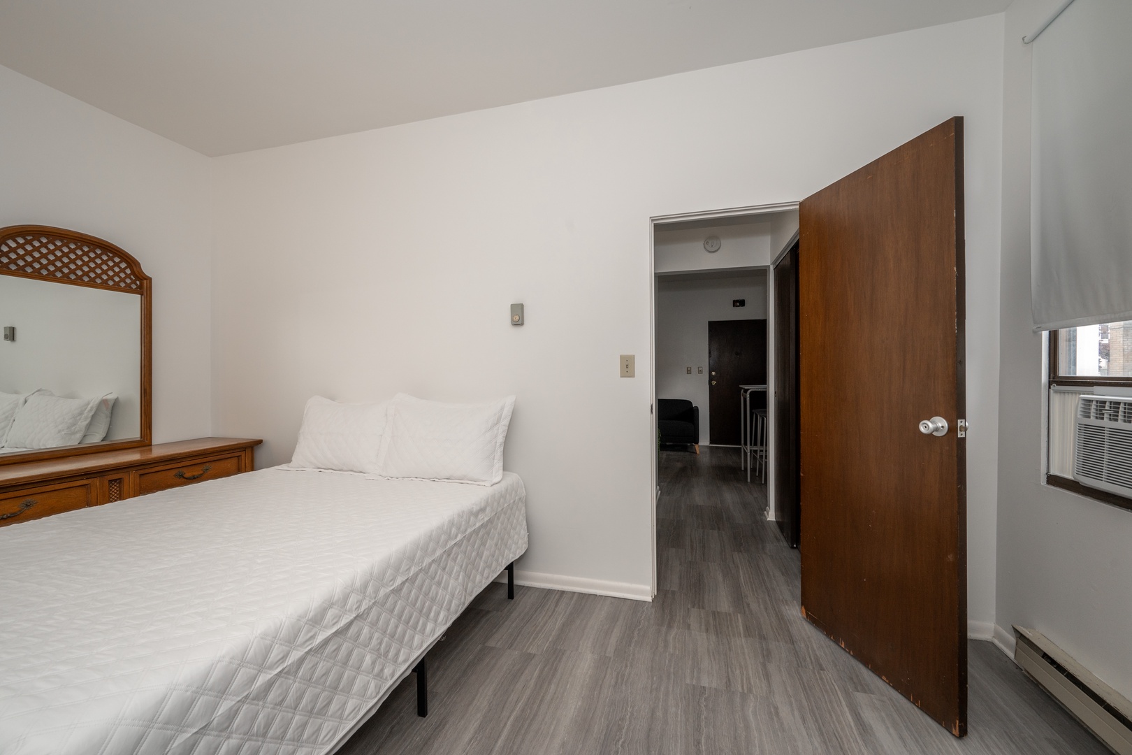 The bedroom retreat features a plush queen-sized bed & large dresser