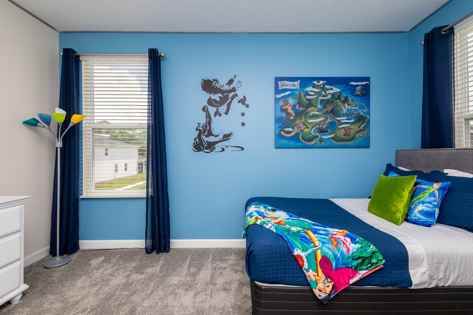 This bedroom’s twin bed, full bed, & smart TV will have you believing in fairies!