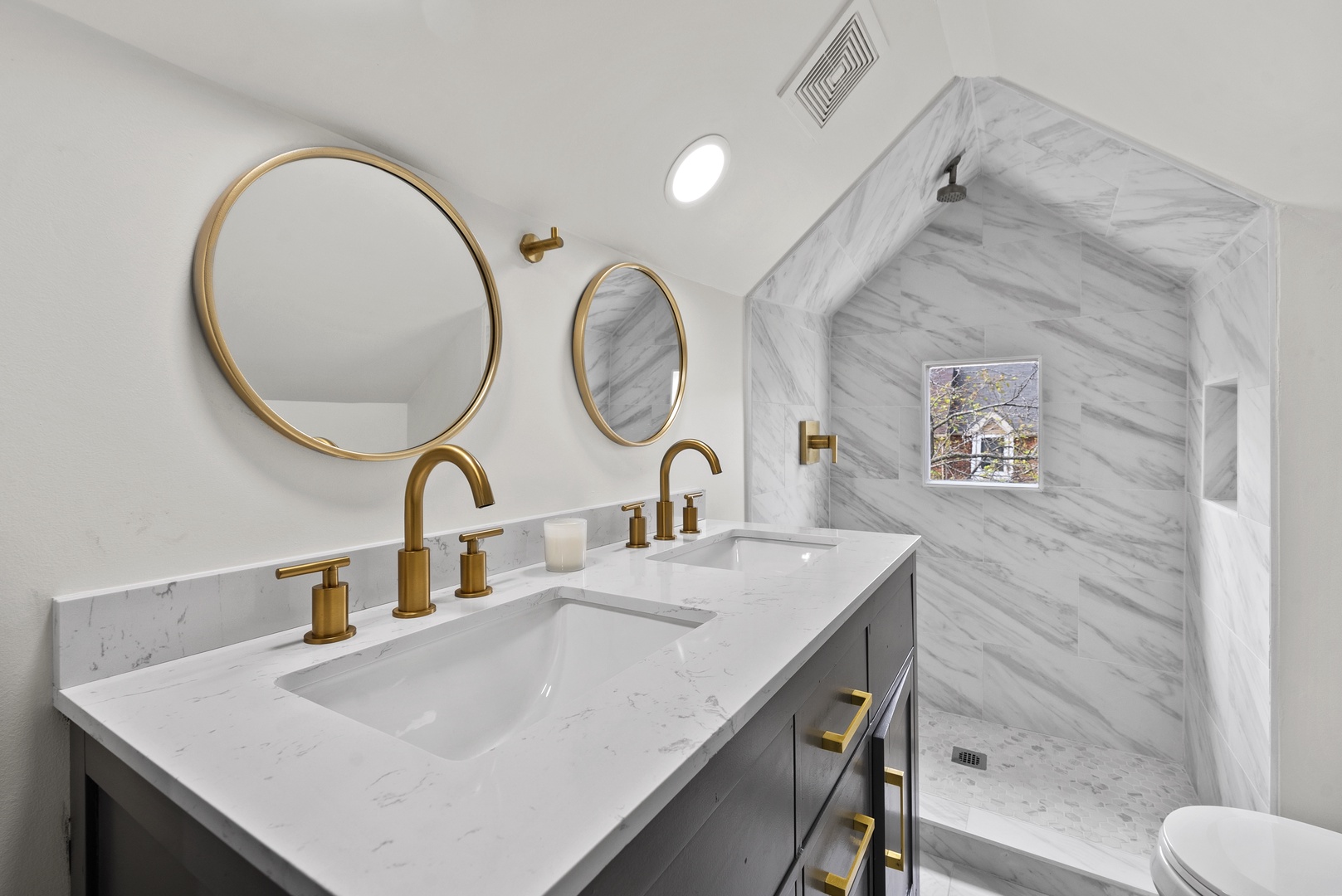 This ensuite bath showcases a double vanity & walk-in shower