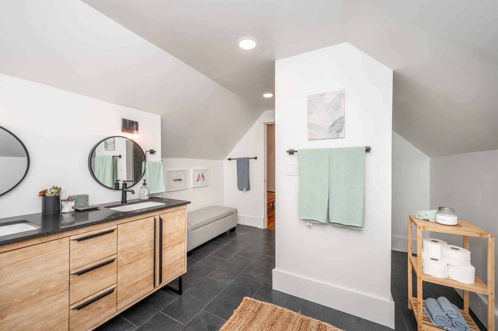 The 3rd-floor full bath showcases a double vanity & shower/tub combo