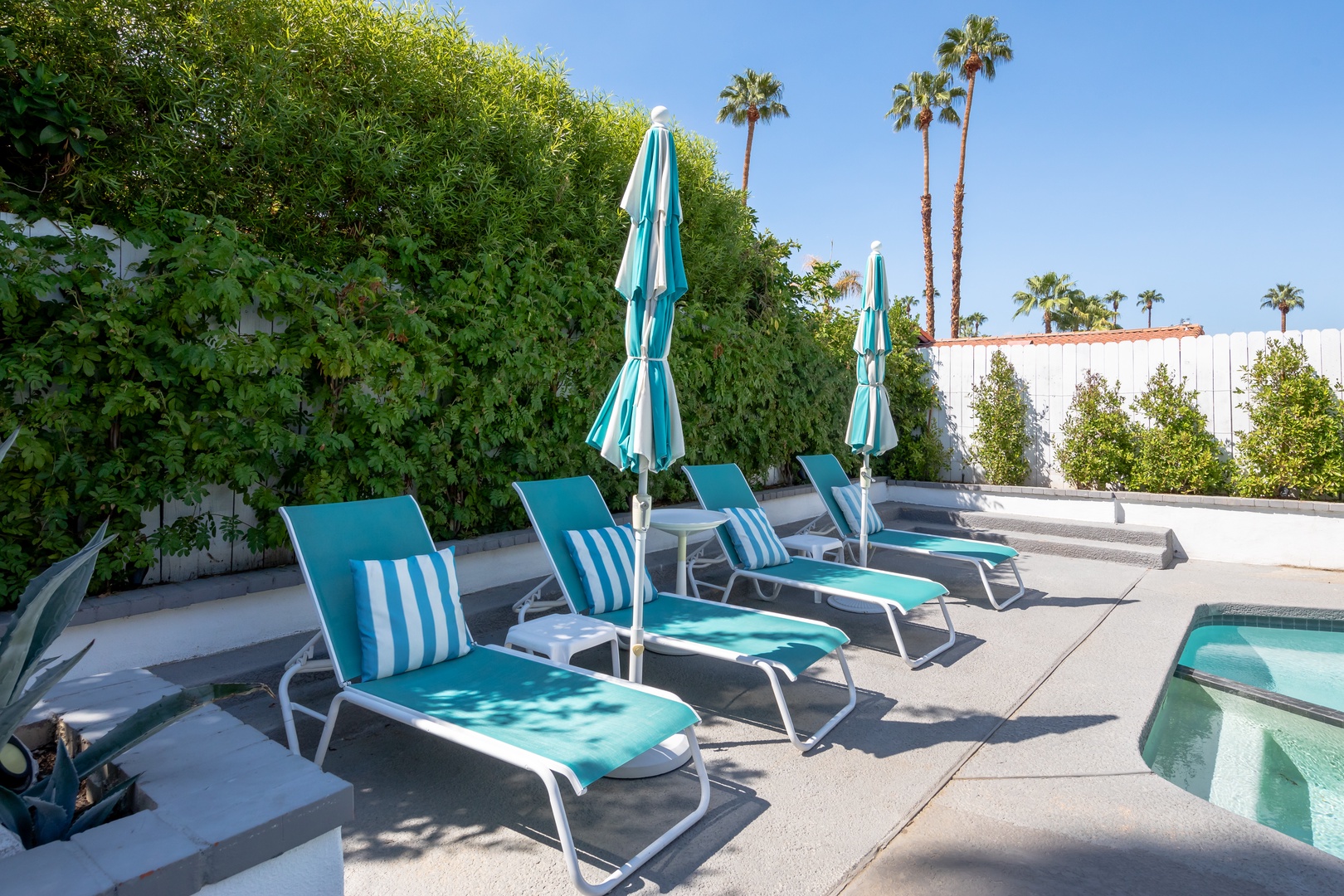Lounge chairs with umbrellas to keep you poolside