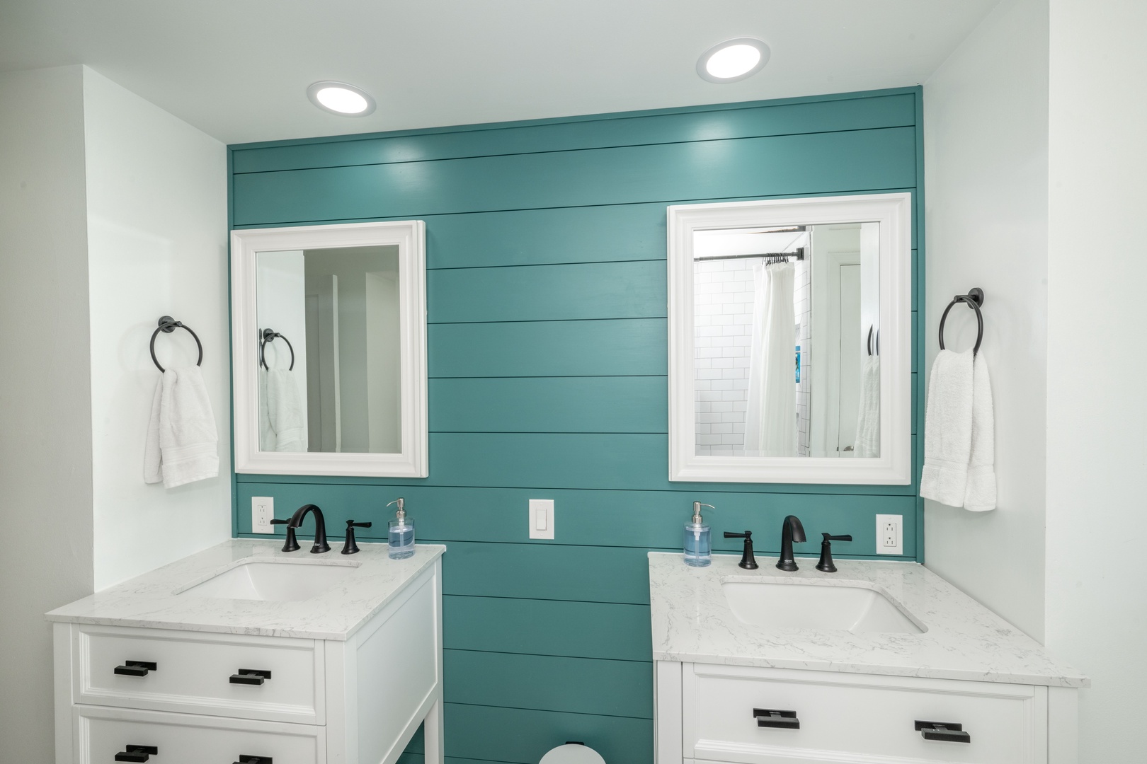 The second-floor full bath includes dual vanities & a shower/tub combo