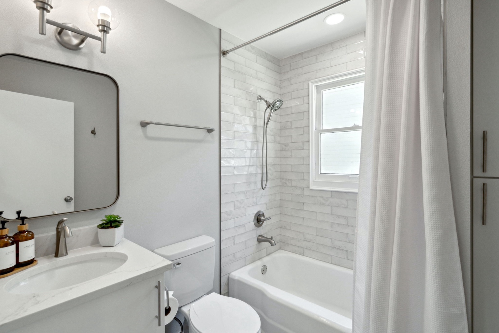 A single vanity & shower/tub combo await in the updated full bathroom