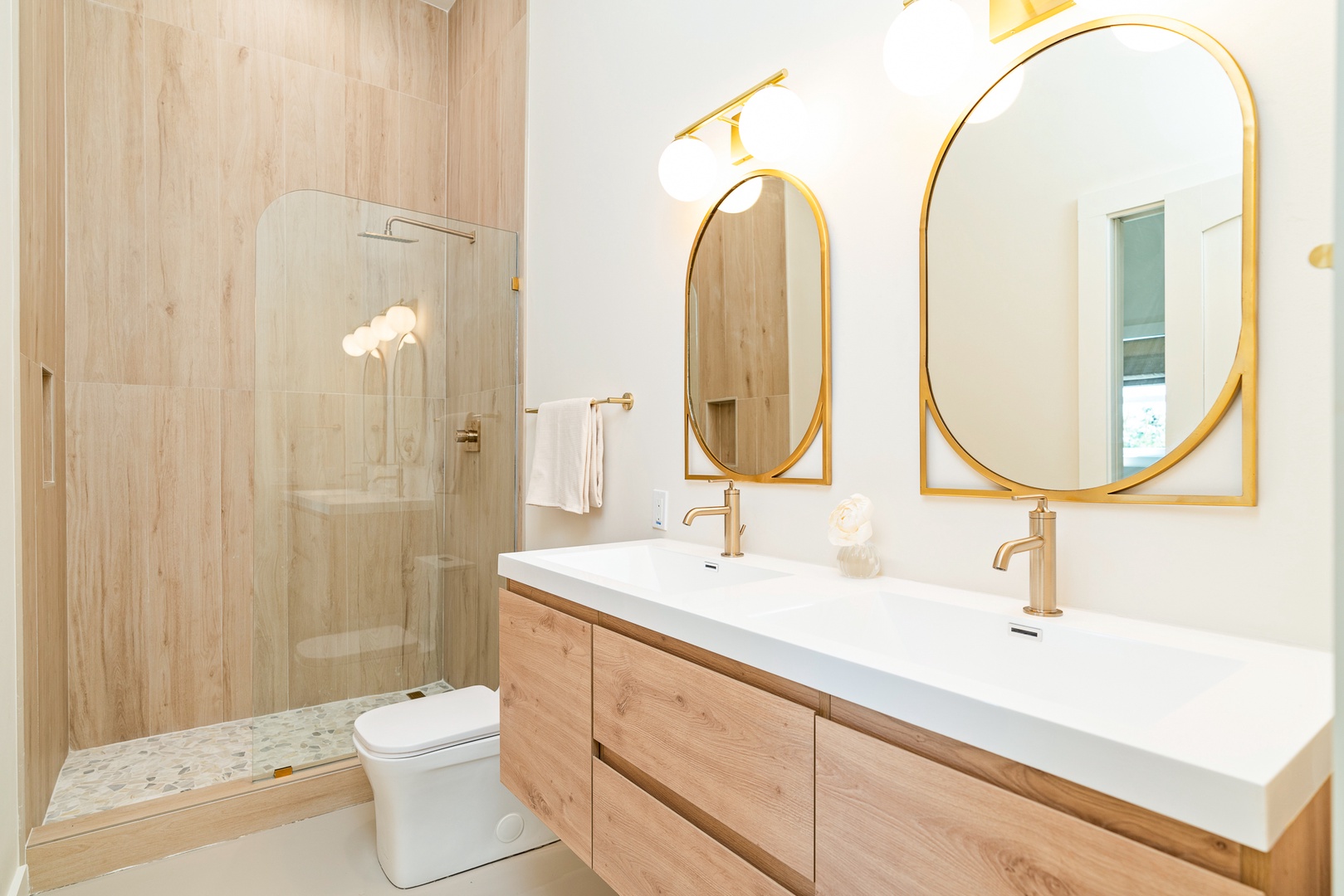 This stylish ensuite features a double vanity & luxe glass shower