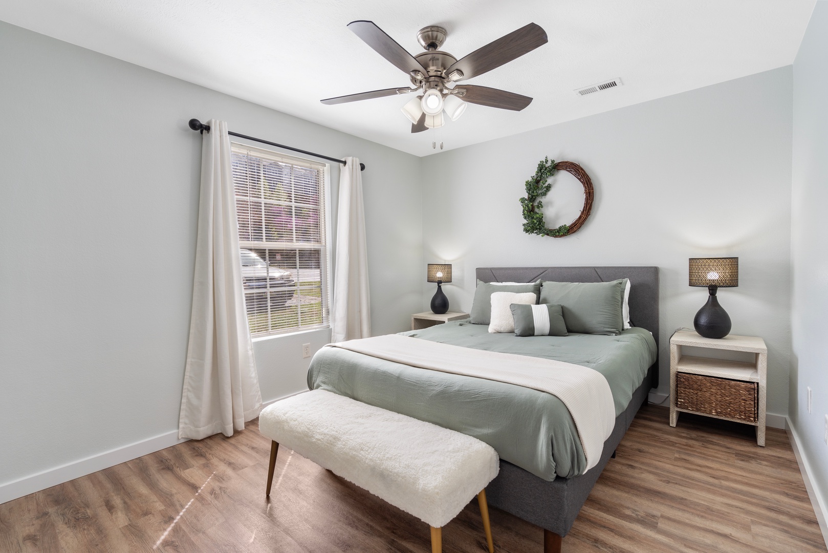 The first bedroom retreat boasts a plush queen bed & Smart TV