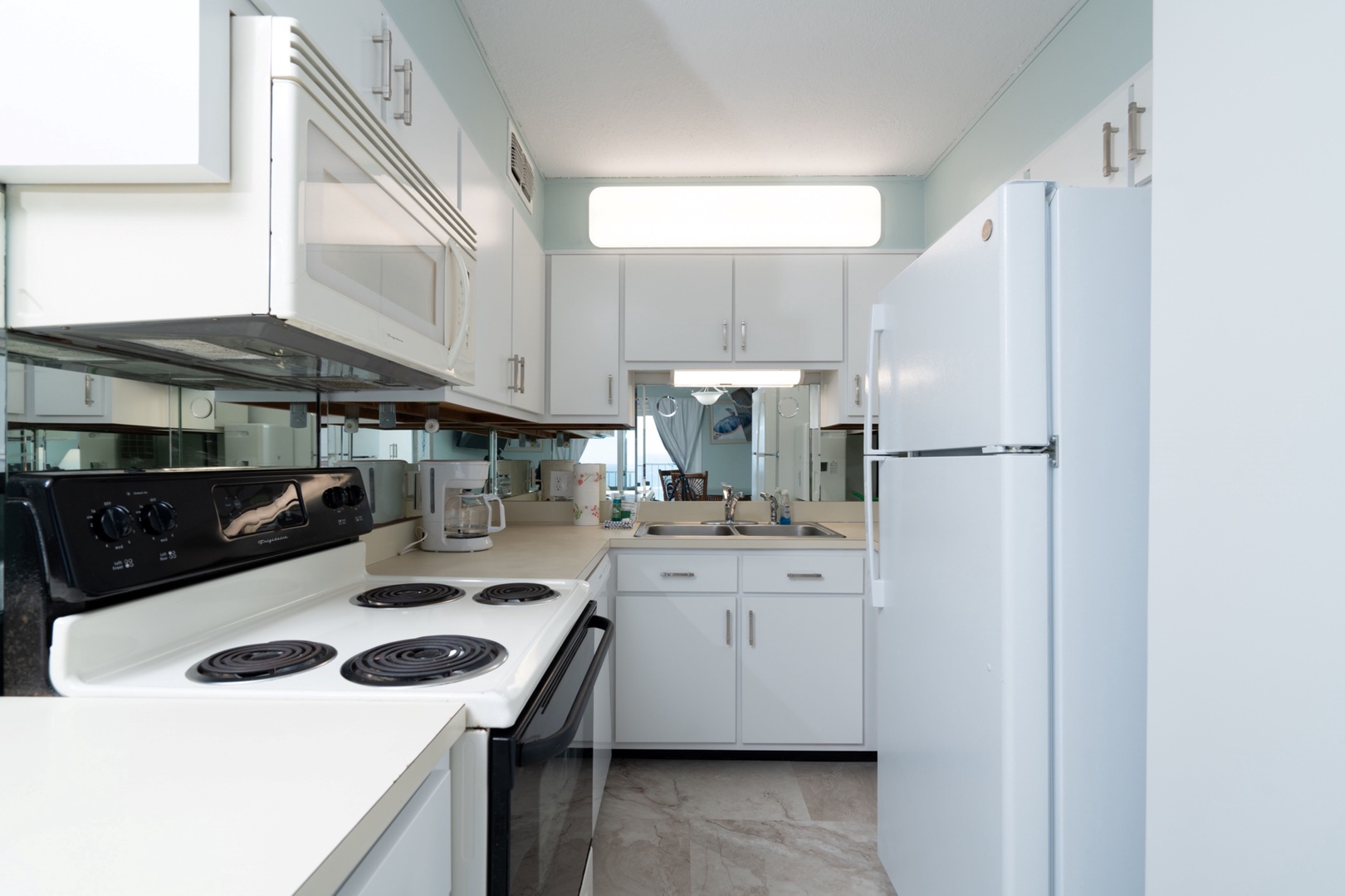 The tranquil kitchen offers ample space & all the comforts of home