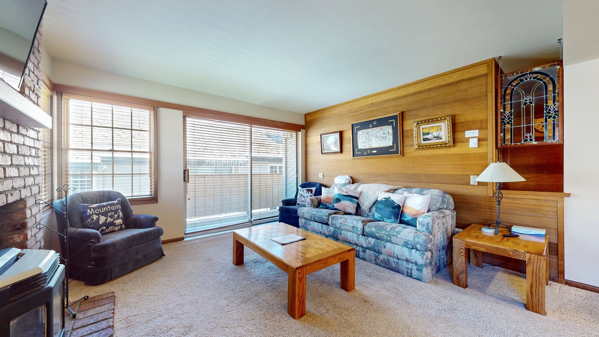 The living room provides ample seating, sofa sleeper, Smart TV, and access to the balcony