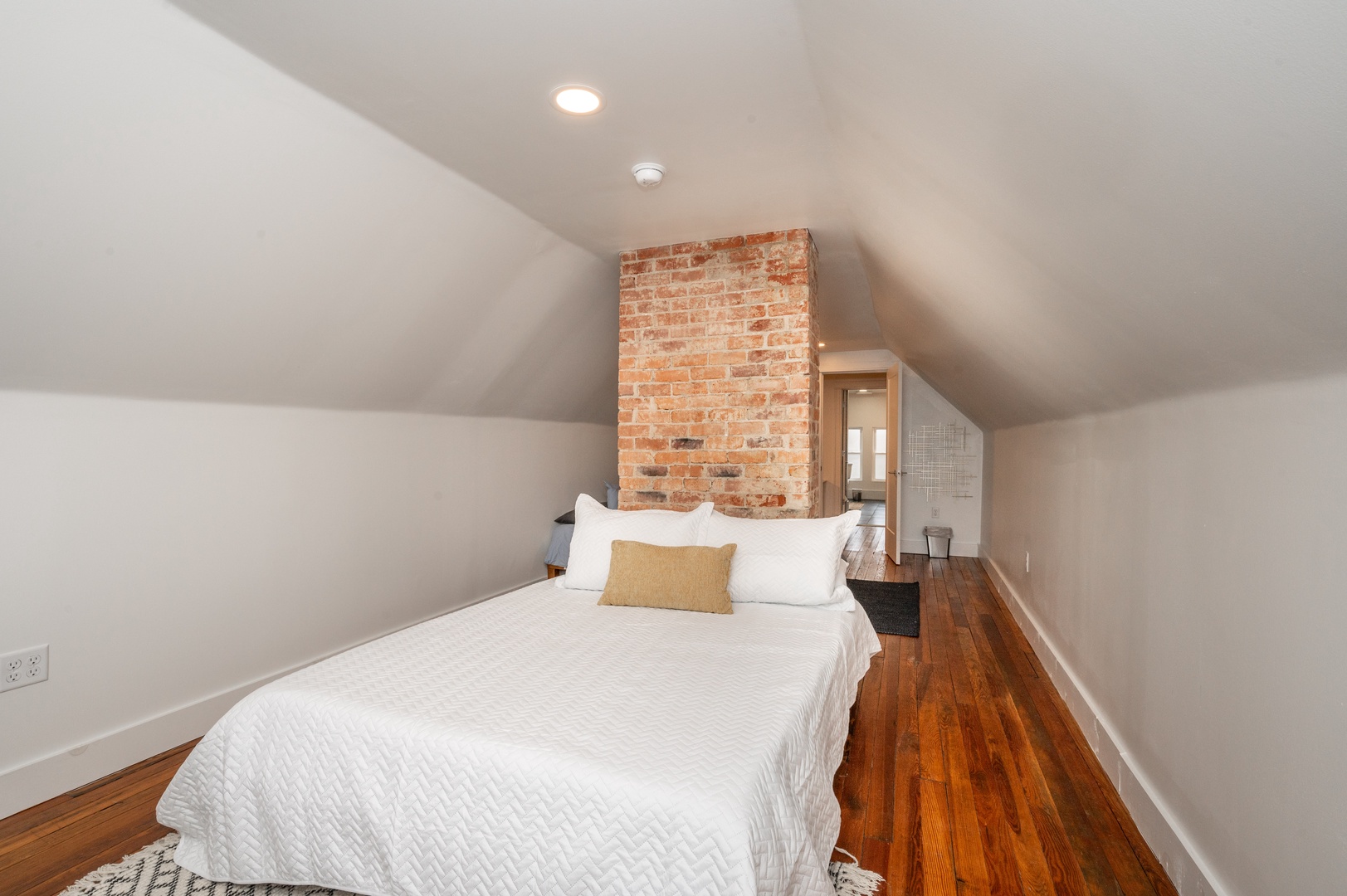 A pair of cozy queen-sized beds are available in this 3rd-floor bedroom