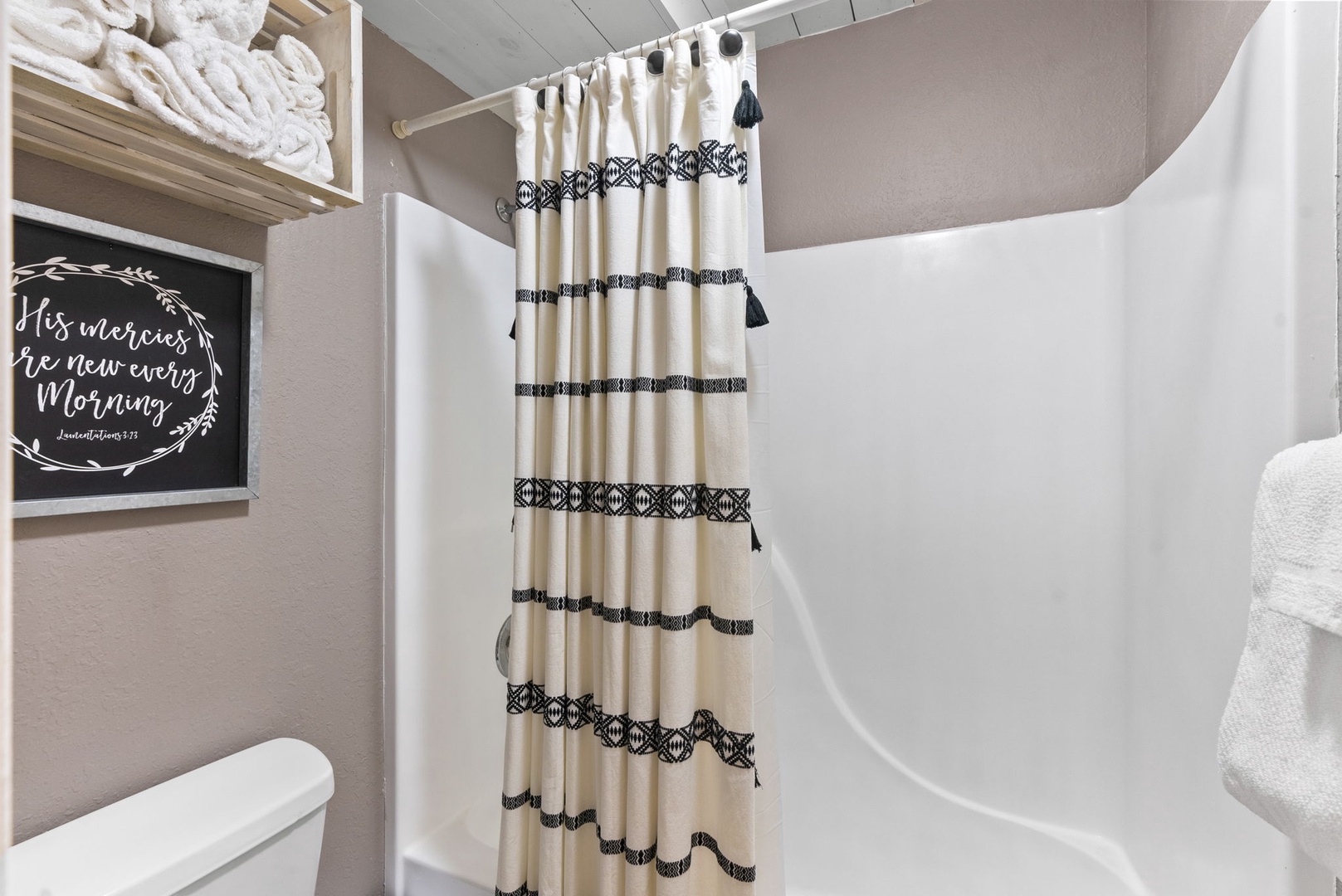 The chic queen en suite boasts an oversized vanity & shower/tub combo