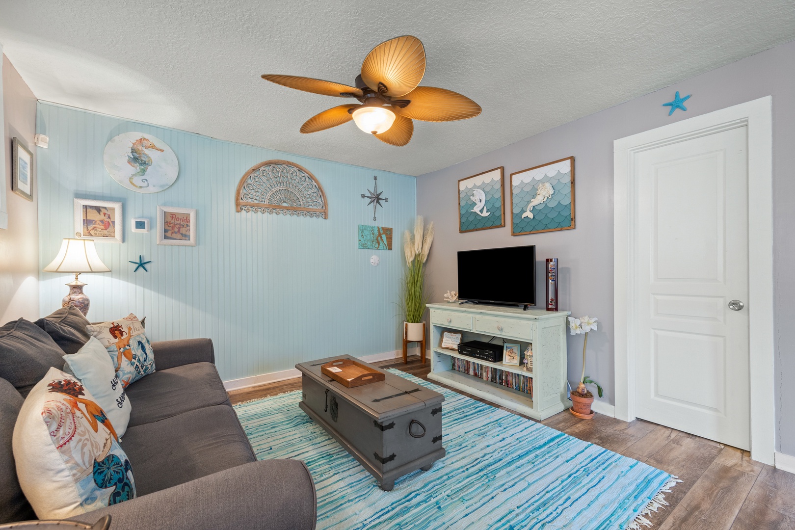 Bright living area with ample seating and Smart TV