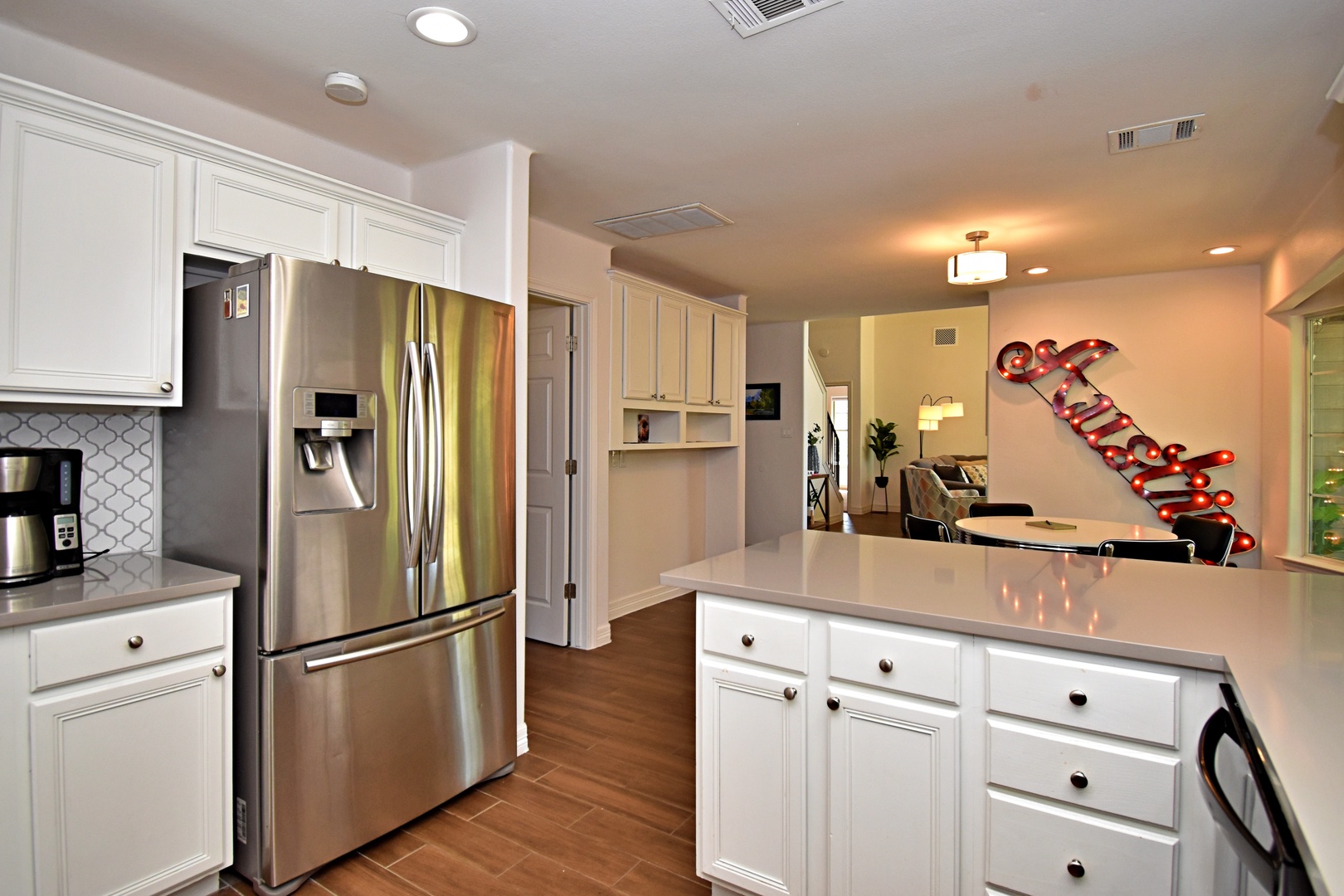 The chic kitchen offers ample space & all the comforts of home