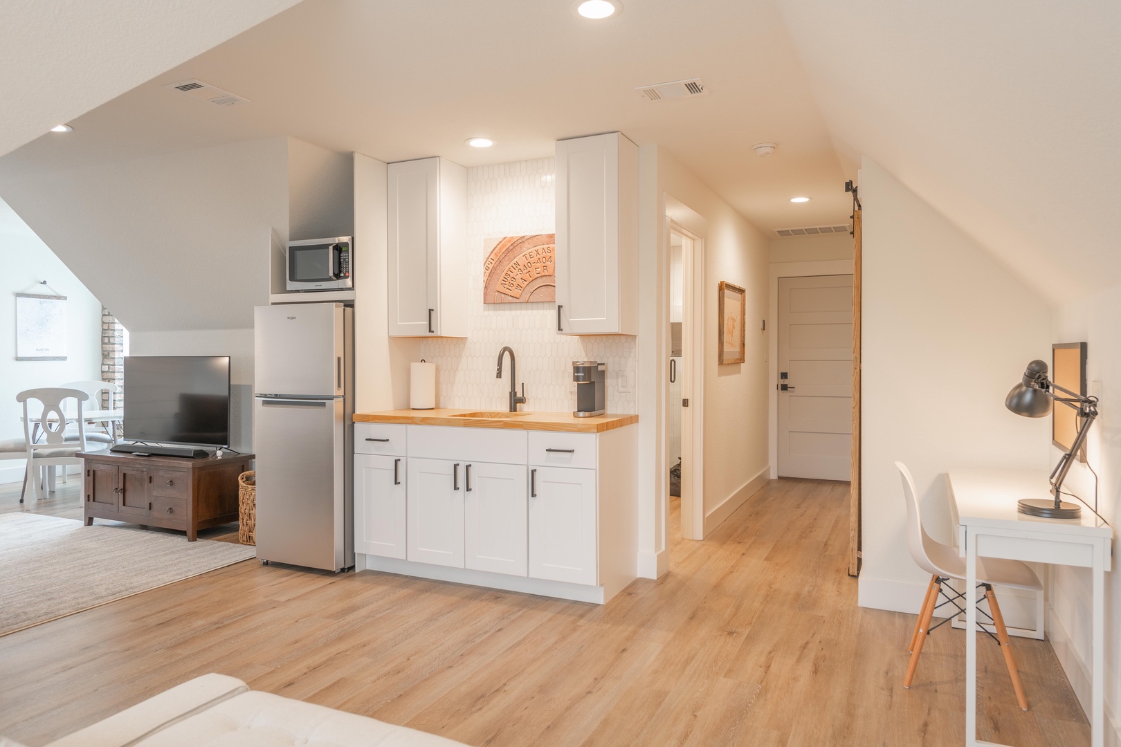 Kitchenette & hallway leading to full bathroom