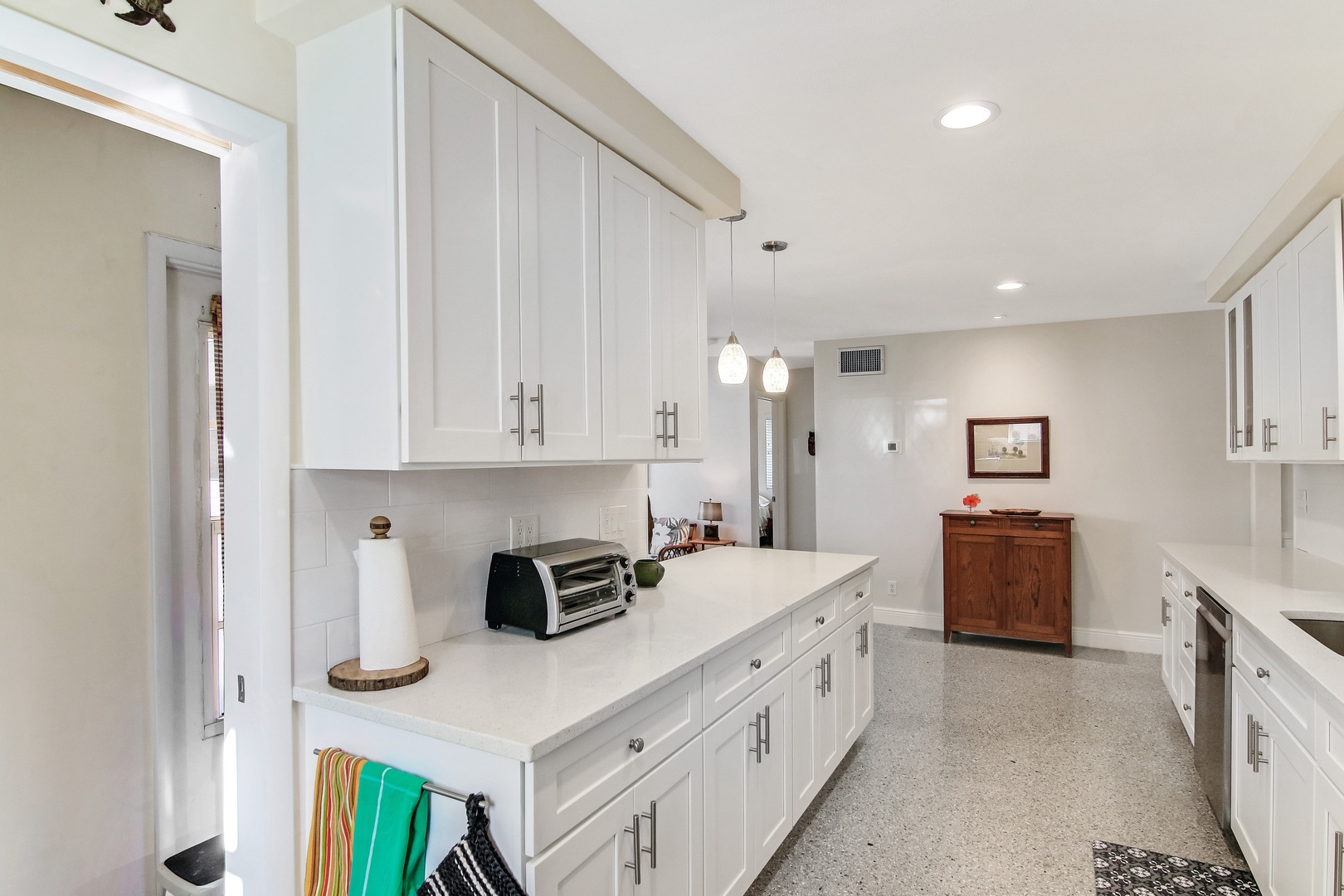 The bright, cheerful kitchen offers ample space & all the comforts of home