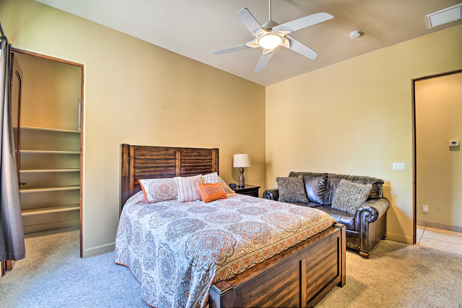 This bedroom includes a comfy queen bed & couch
