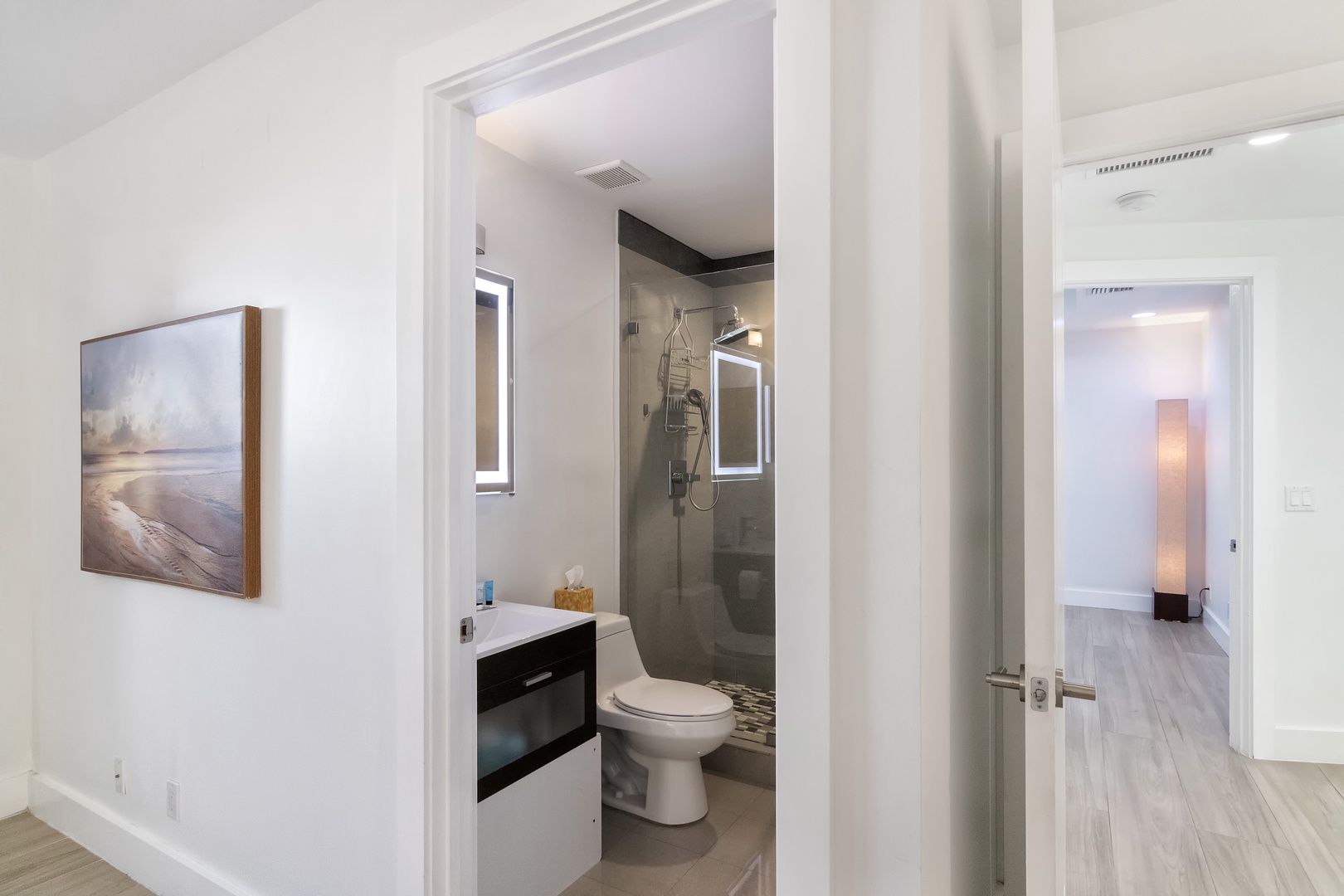 A single vanity & luxurious glass shower await in this 1st-floor ensuite