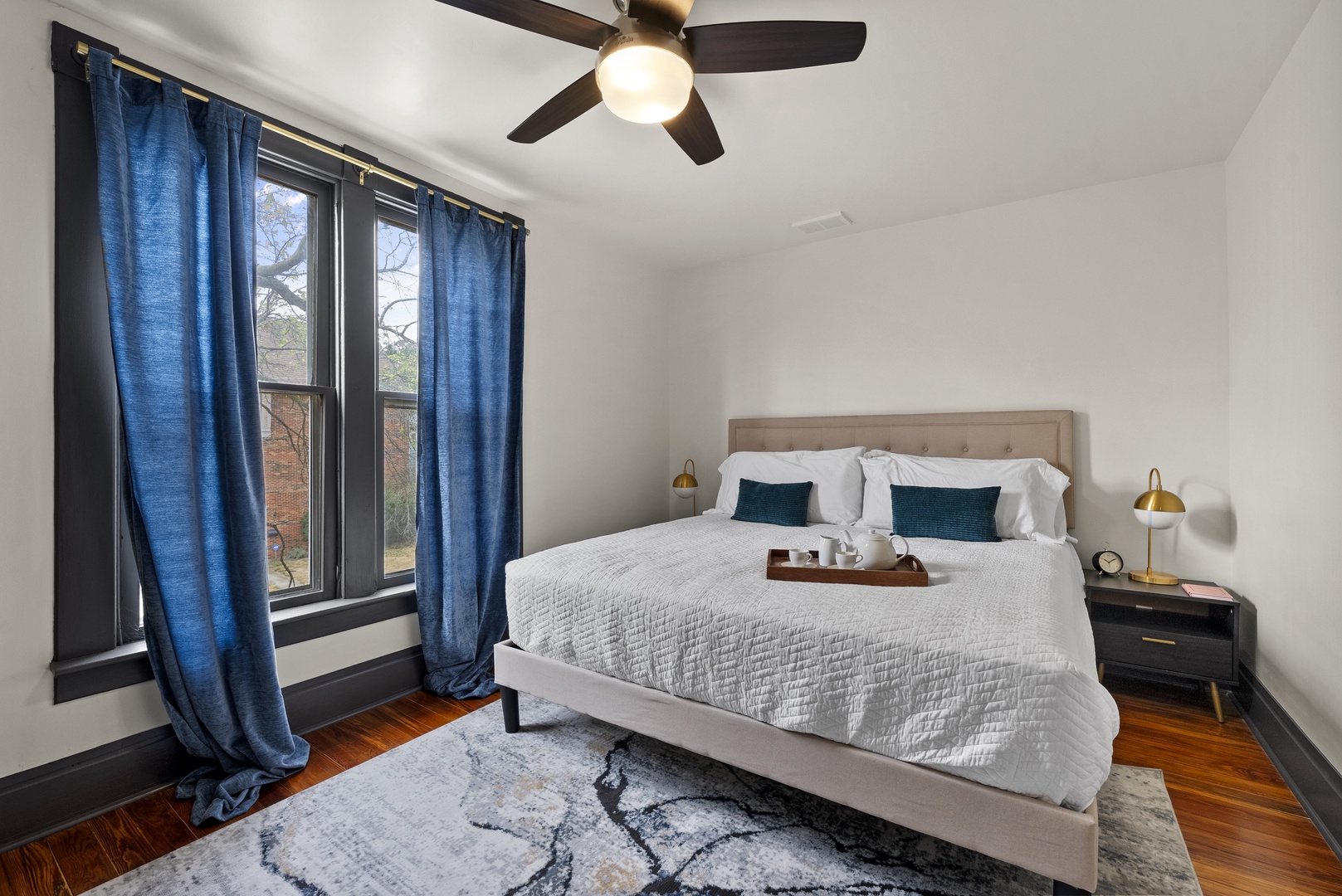 The cozy 2nd floor king bedroom includes a ceiling fan