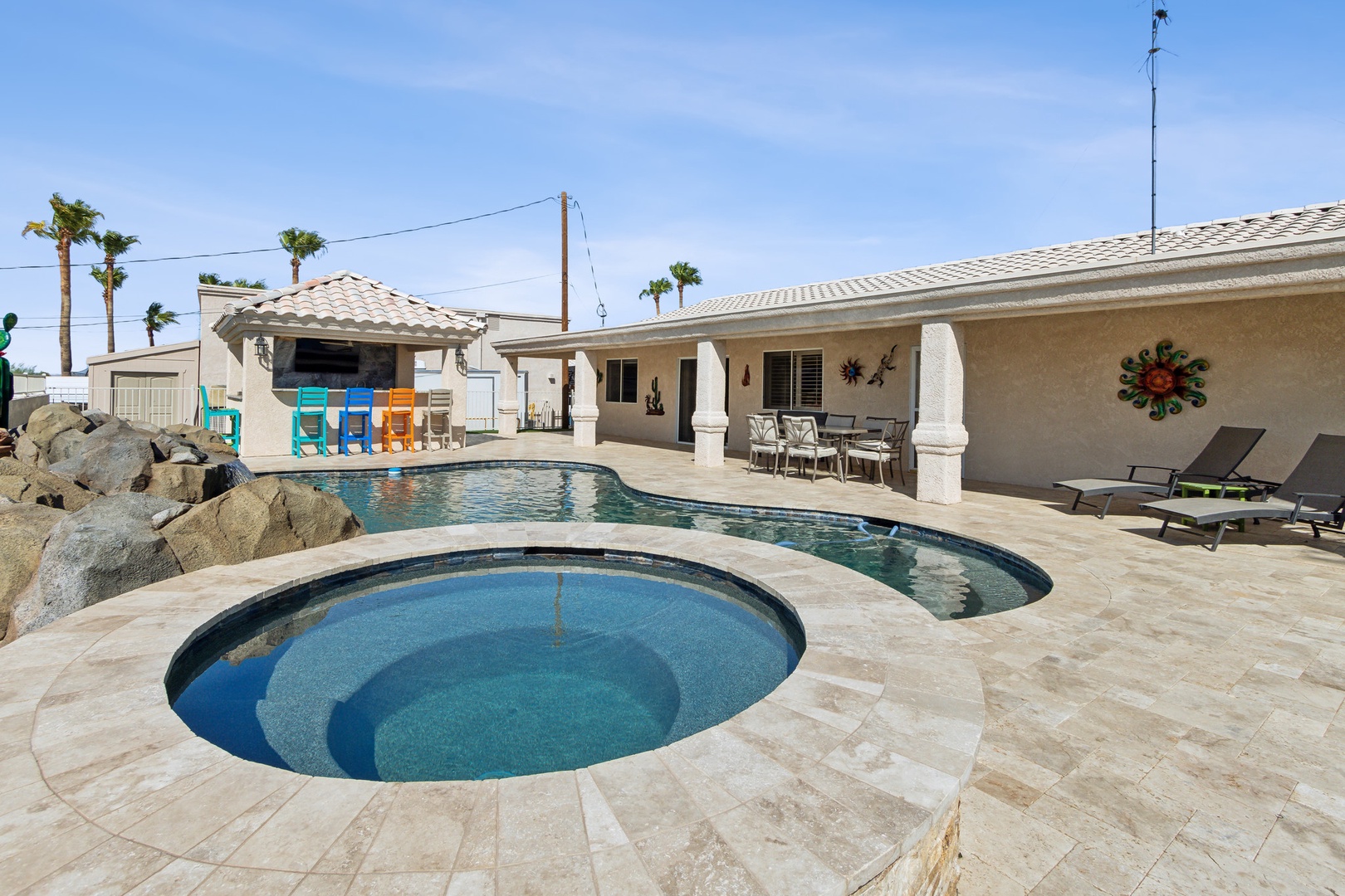 A mountain-view oasis, with a waterfall pool, hot tub, & outdoor kitchen!