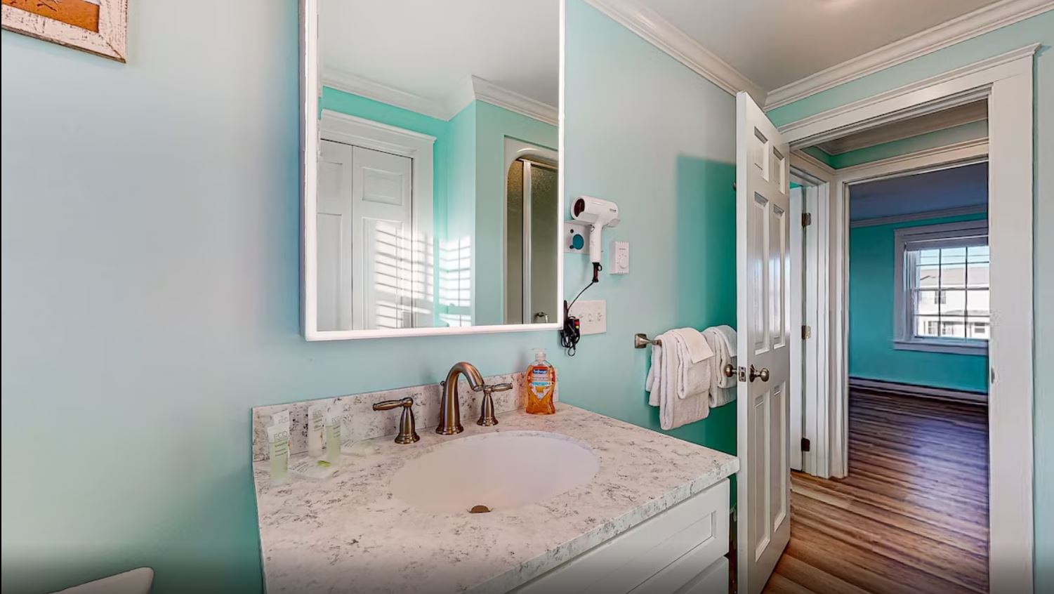 A single vanity & walk-in shower await in this beachy ensuite bath