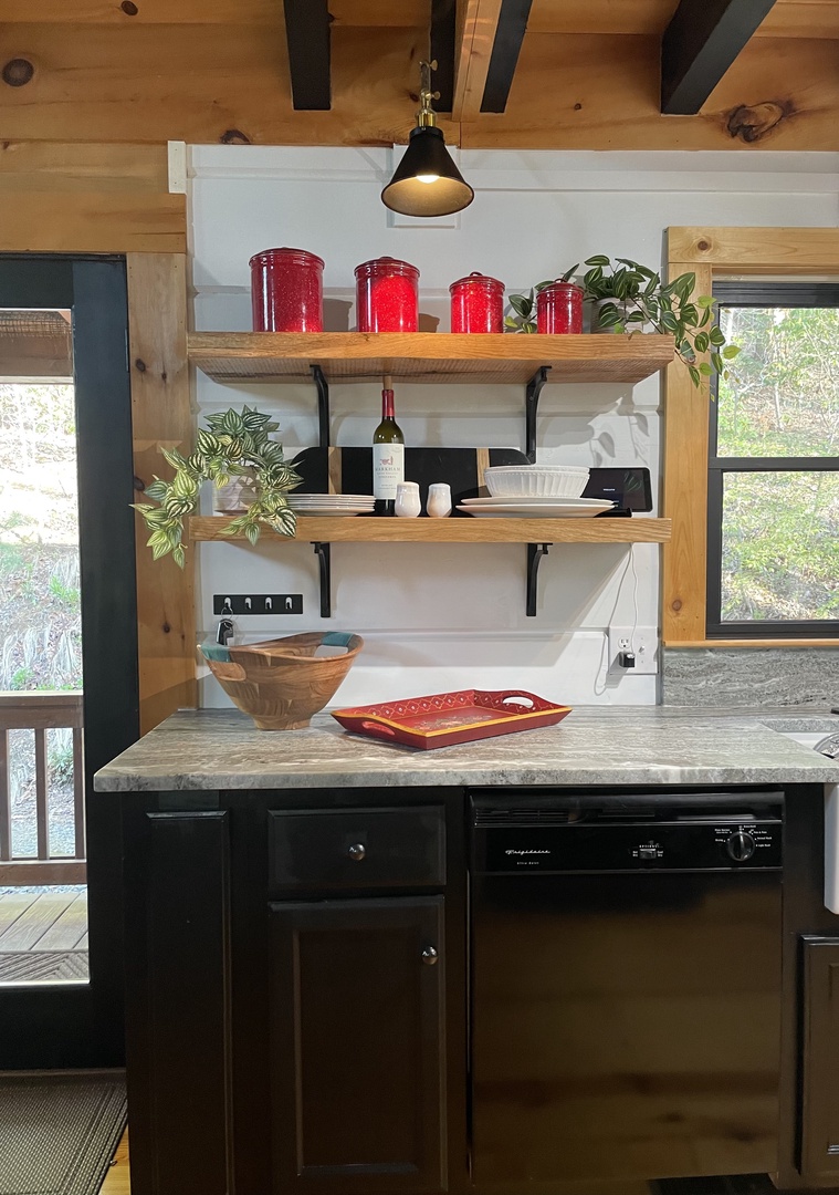 Leather granite countertops and open shelving create a warm and inviting Kitchen